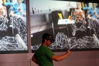 A demonstrator scanning a room with HoloLens